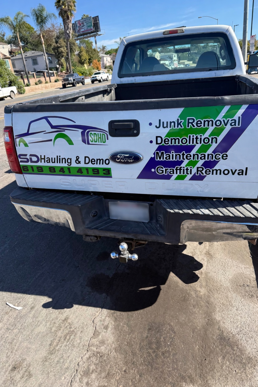 SD Hauling and Demo truck rear wrap with services listed